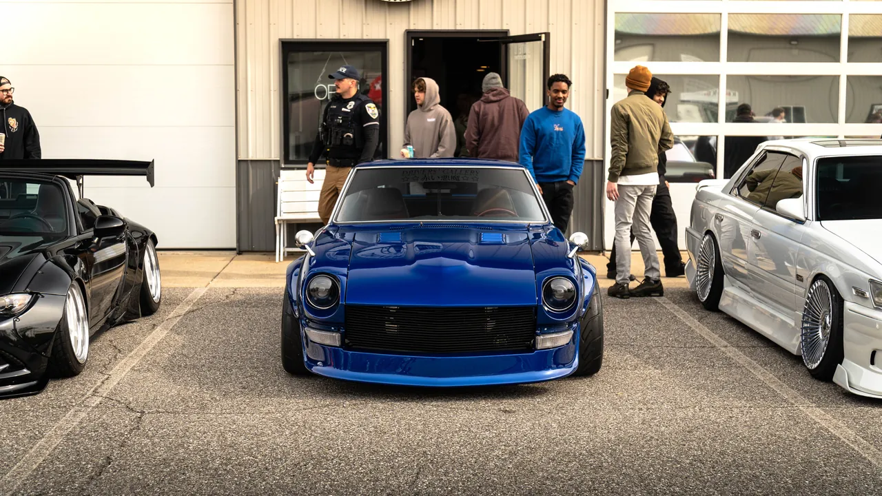 Blue widebody Datsun 240Z parked low at a Chicagoland car meet
