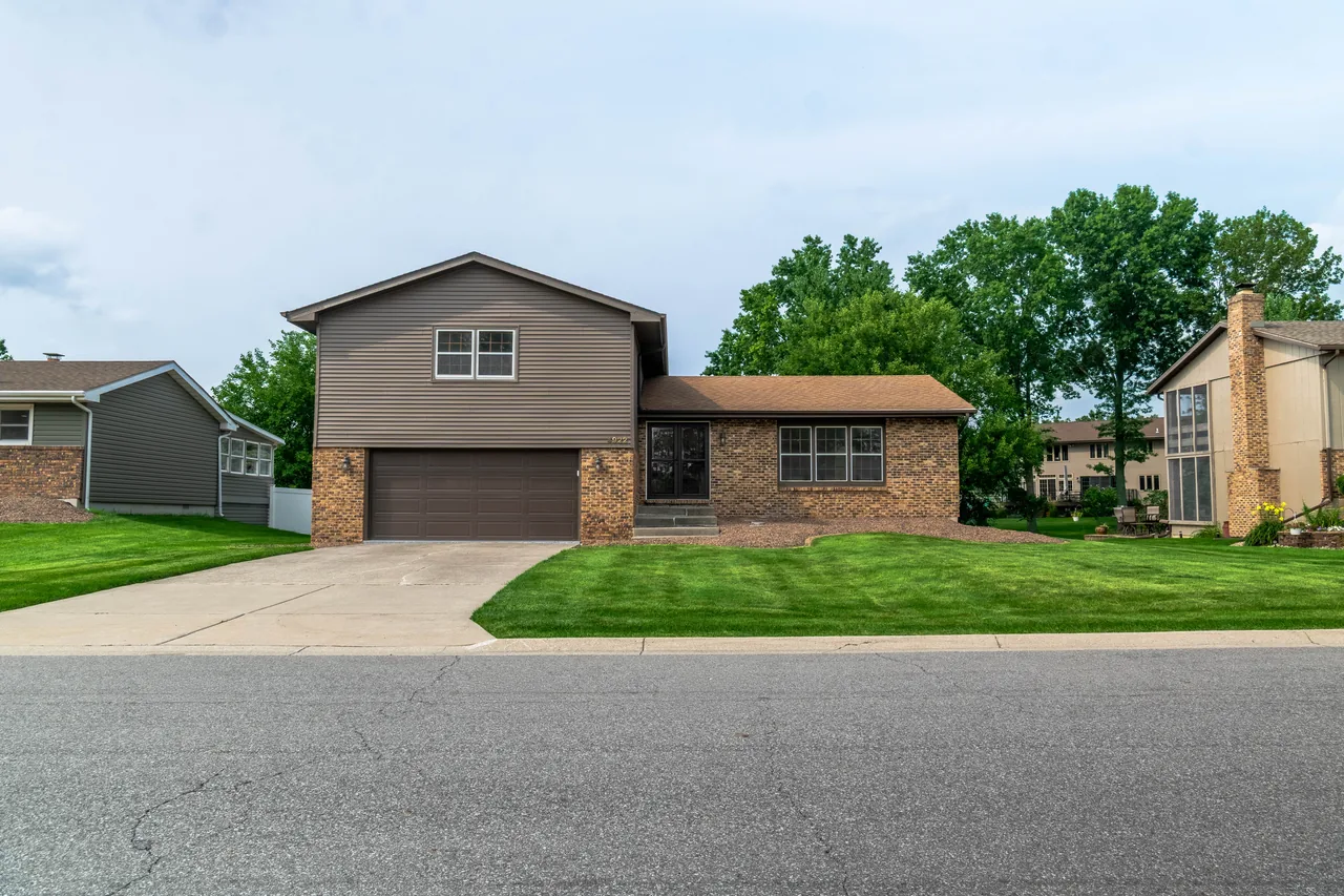 Street-level view of the home's front elevation, driveway and garage