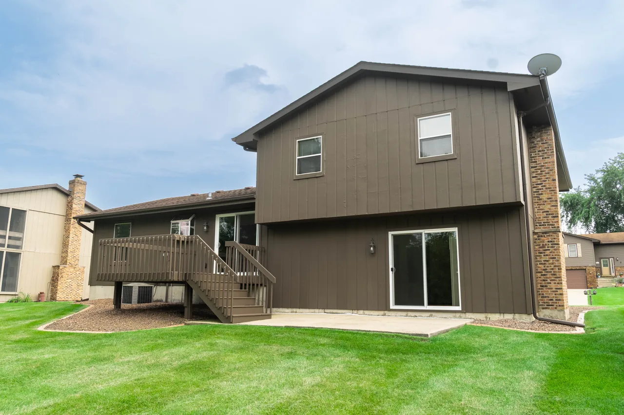 Rear elevation of the home showing the raised deck, patio and lower level